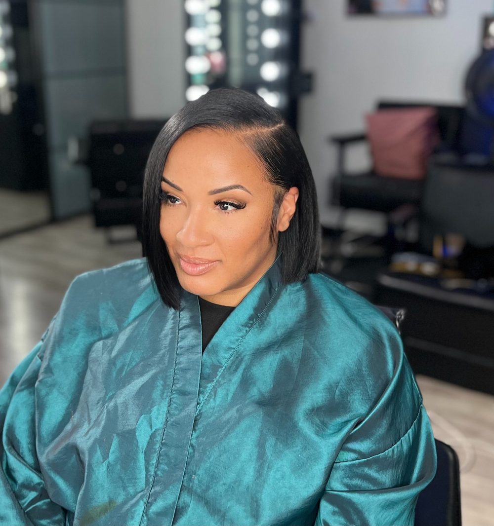 Client sleek angled bob sew-in with a side part and a glossy straight finish