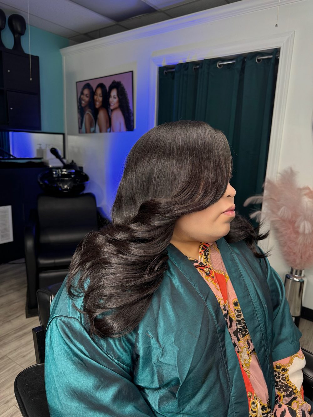 Client sew-in seen from the side, showing soft curls through the back and a smooth blend at the crown
