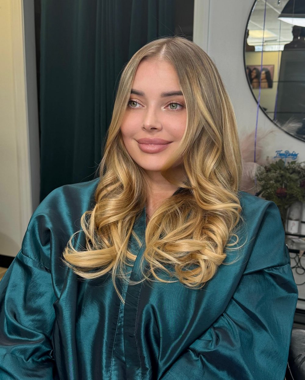 Client with a long blonde install finished in soft curls