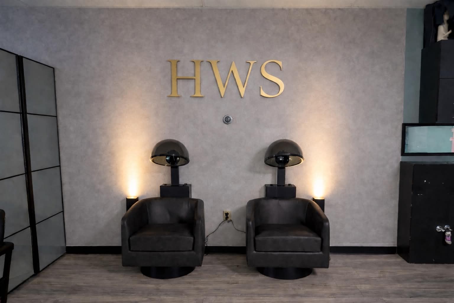 HWS studio dryer chairs beneath the gold HWS wall sign